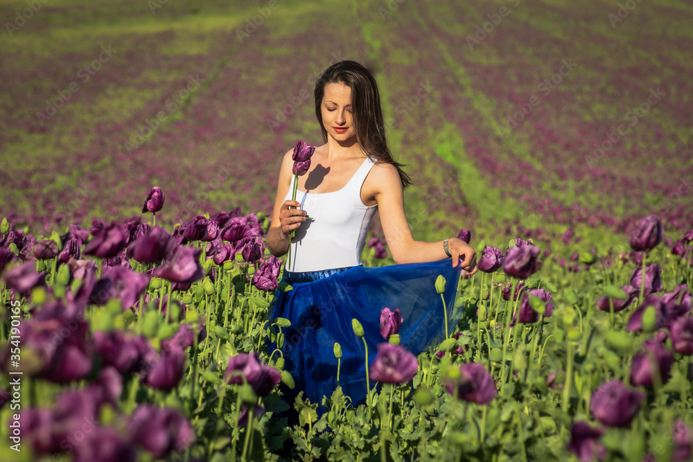 portrait of happy beautiful woman in the sunny summer field of purple poppy flower portrait of happy beautiful woman in the sunny summer field of purple poppy flower