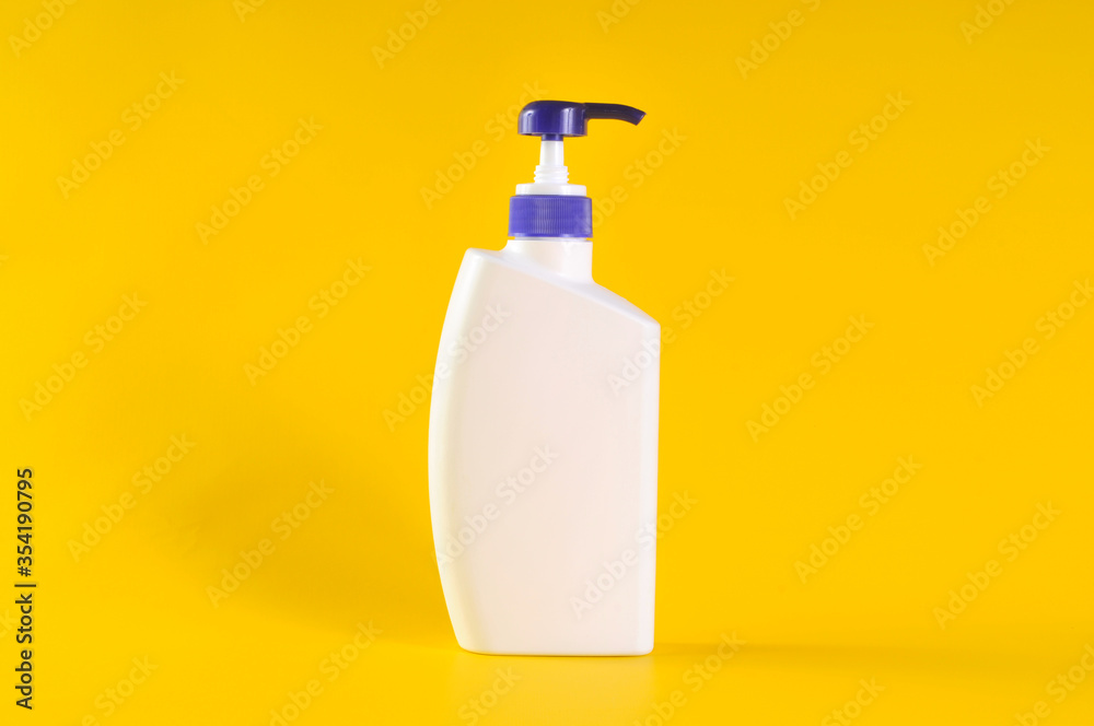 Blank label bottle of antibacterial liquid soap and hand sanitizer mockup on yellow background. White unbranded dispenser bottle isolated on yellow background. Hygiene product and health care. Blank label bottle of antibacterial liquid soap and hand sanitizer mockup on yellow background. White unbranded dispenser bottle isolated on yellow background. Hygiene product and health care.