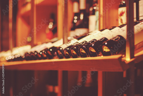 Canvas Print bottles of wine in wine bar or wine shop for soft background