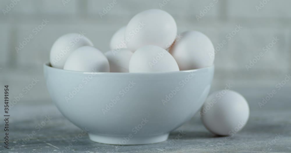 Bowl with fresh raw white egg rotates slowly. Bowl with fresh raw white egg rotates slowly.