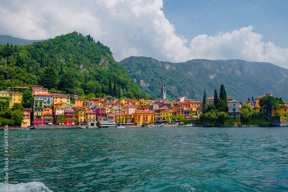 Bellagio lake Como city view. Colorful European houses blue water green Italian Alps in summer tourist season. Lombardy tourism attractions are closed. Comune Province of Como Varenna landscape