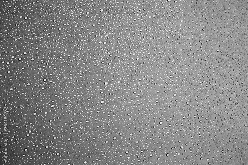 Rain drops or water droplets on a gray background