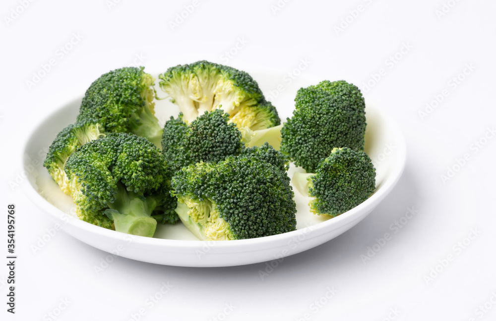 fresh broccoli in a dish on white background fresh broccoli in a dish on white background