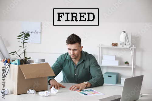 Sad fired man sitting at ta...