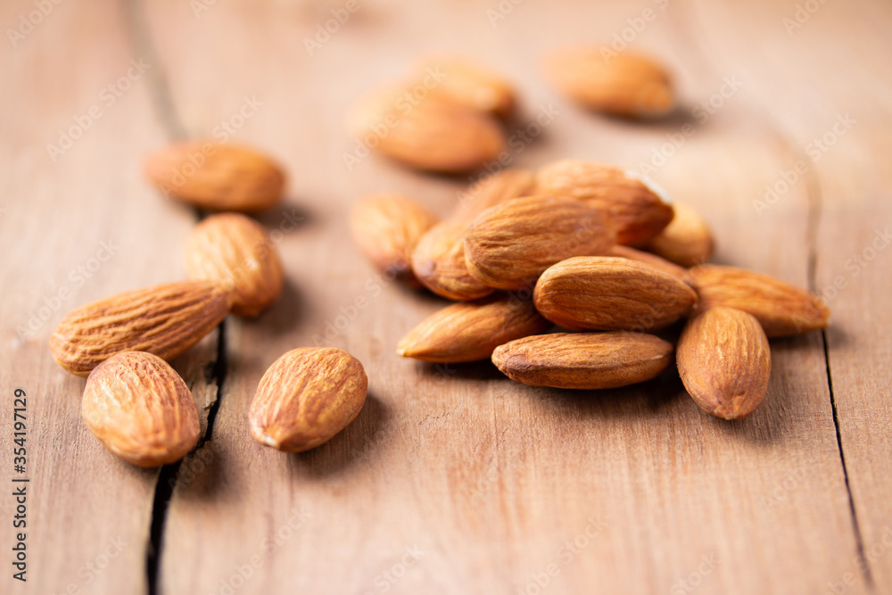 side view Select focus peeled almond in wood spoon wood table almond Nuts Ready to use with advertising text side view Select focus peeled almond in wood spoon wood table almond Nuts Ready to use with advertising text