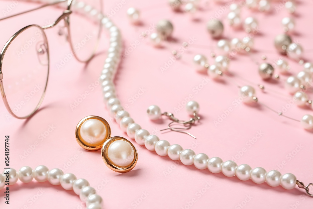 Beautiful jewelry with eyeglasses on color background Beautiful jewelry with eyeglasses on color background