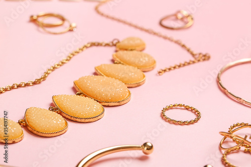 Beautiful jewelry on color background