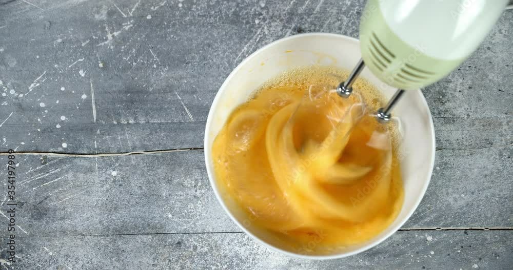 Faw eggs whipped with mixer to prepare homemade cookies. Faw eggs whipped with mixer to prepare homemade cookies.