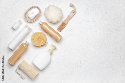 Shower gels with bath supplies on white background