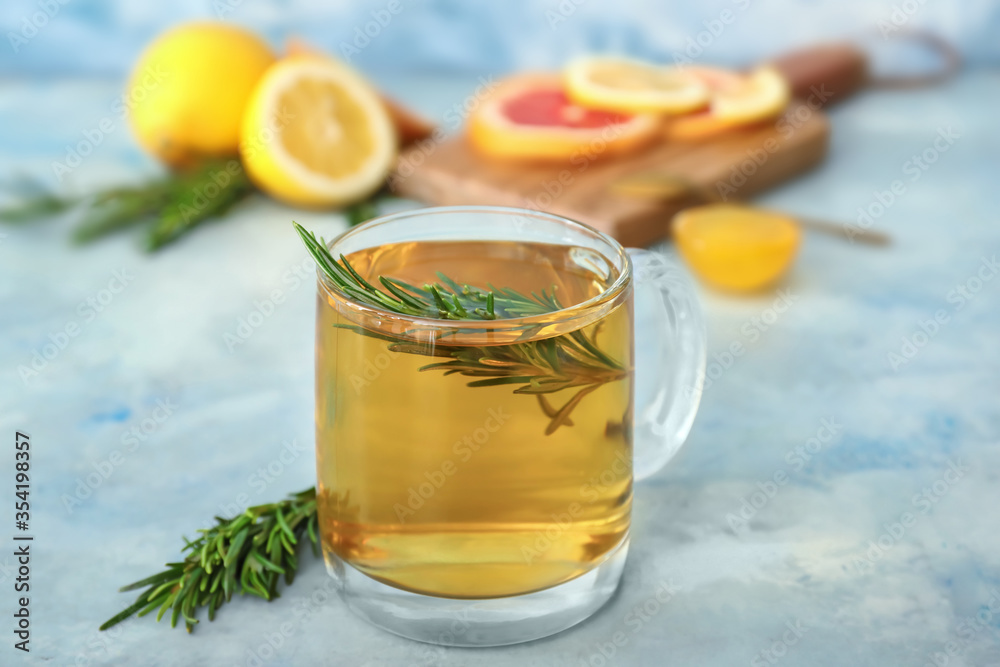 Cup of hot tea with rosemary on color background Cup of hot tea with rosemary on color background