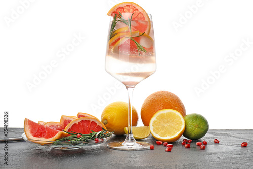 Glass of healthy cocktail on table against white background