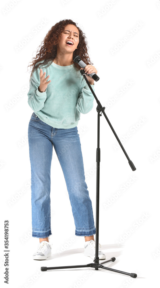 Young African-American woman singing on white background