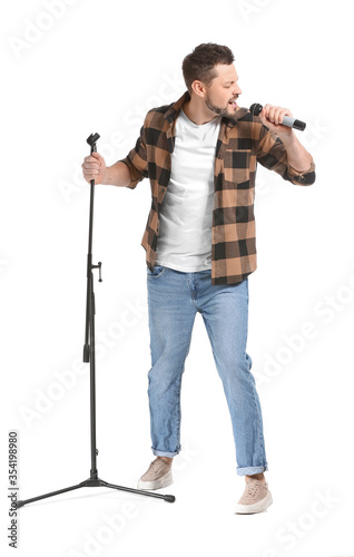 Handsome man singing against white background