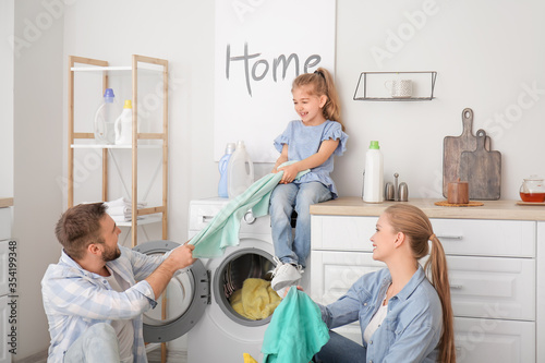 Happy family doing laundry ...