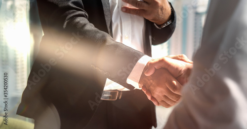 businessman handshake for teamwork of business merger and acquisition photo