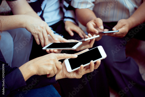 group of people using smartphone for online shopping learning working concept.
