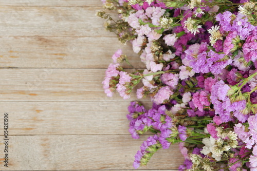 Blossom Lavender Limonium flower bouquet on old wooden table,top view for copy space