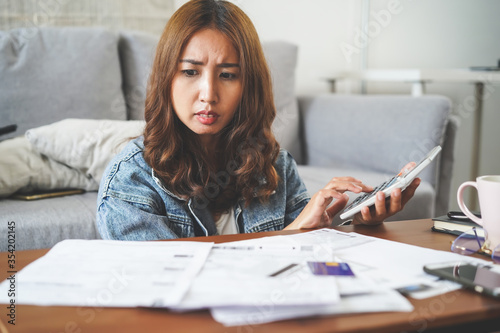 stressed woman calculating monthly expense andpayment bill invoice.