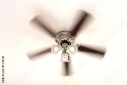 turning ceiling fan with blurred motion on white background 