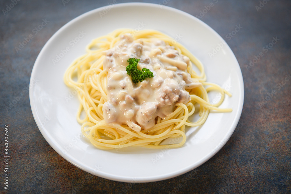 Spaghetti italian pasta served on white plate with parsley in the restaurant italian food and menu concept - spaghetti carbonara