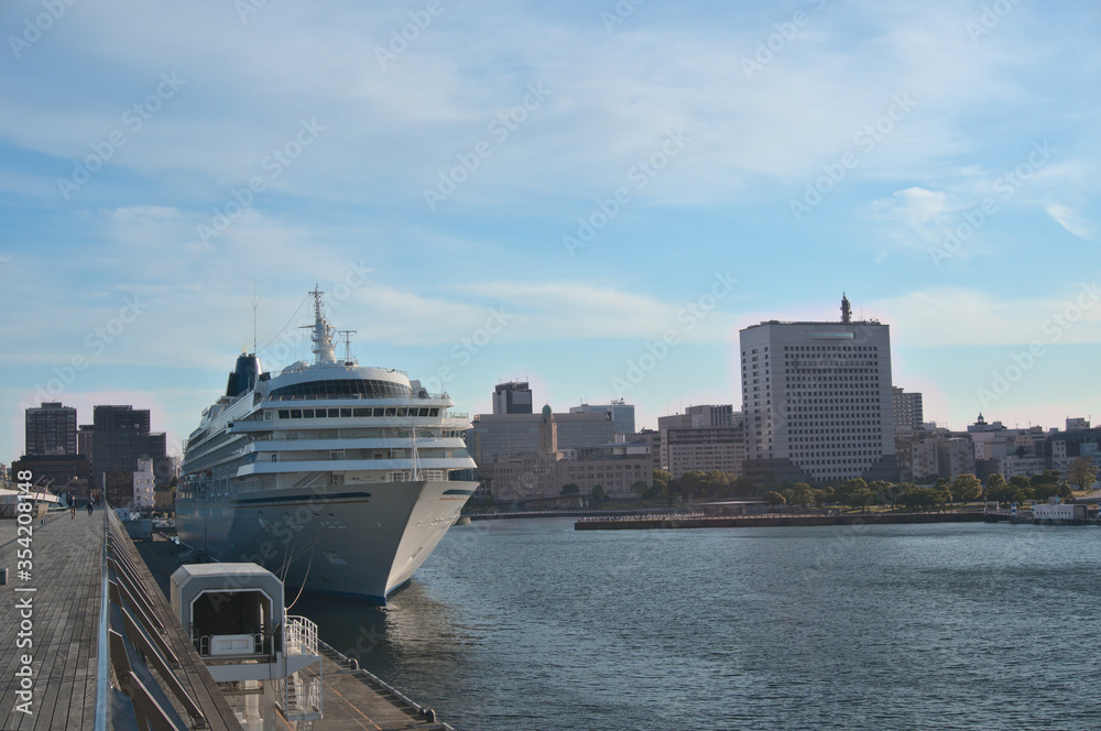 Big Cruiser anchoring at Yokohama International Terminal Port (Osanbashi) in Yokohama City, Kanagawa Prefecture, Japan with clear blue sky and sunny and unidentified tourist as background