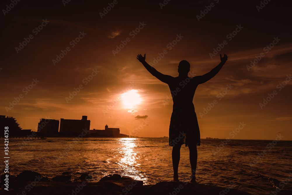 Silhouette of a man against the setting sun.