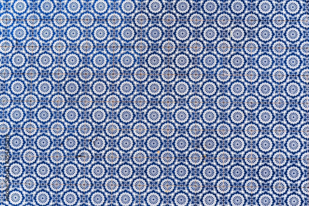 Typical traditional portuguese ceramic titles -Azulejo blue and white ornament, facade wall in Portugal Typical traditional portuguese ceramic titles -Azulejo blue and white ornament, facade wall in Portugal