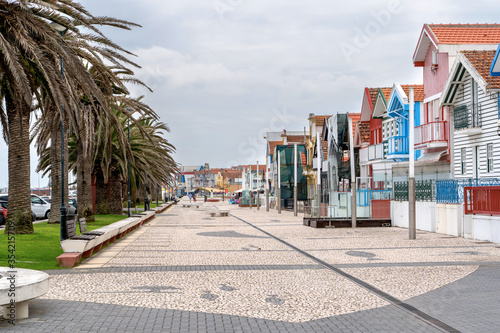 Street with colorful striped houses, Costa Nova, Aveiro, Portugal. Facades of colorful fisheman houses in Costa Nova, Aveiro, Portugal