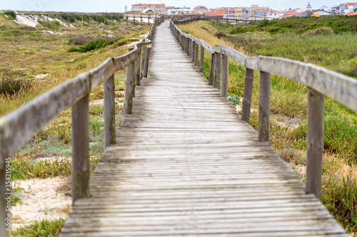 Wooden path at over sand dunes. Wooden footbridge of Costa Nova beach in Aveiro  Portugal.