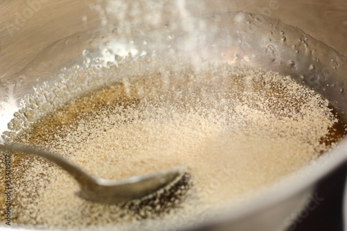 Pouring white breadcrumbs into saucepan with golden syrup. Making Shoofly Tart Series. photo