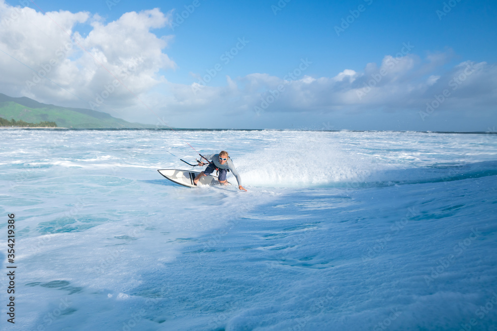Kitesurfer rides on the waves of the Indian Ocean on the island of Mauritius