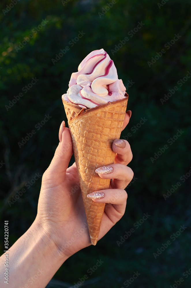 girls hands hold ice cream. girl eating ice cream with a wooden spoon girls hands hold ice cream. girl eating ice cream with a wooden spoon