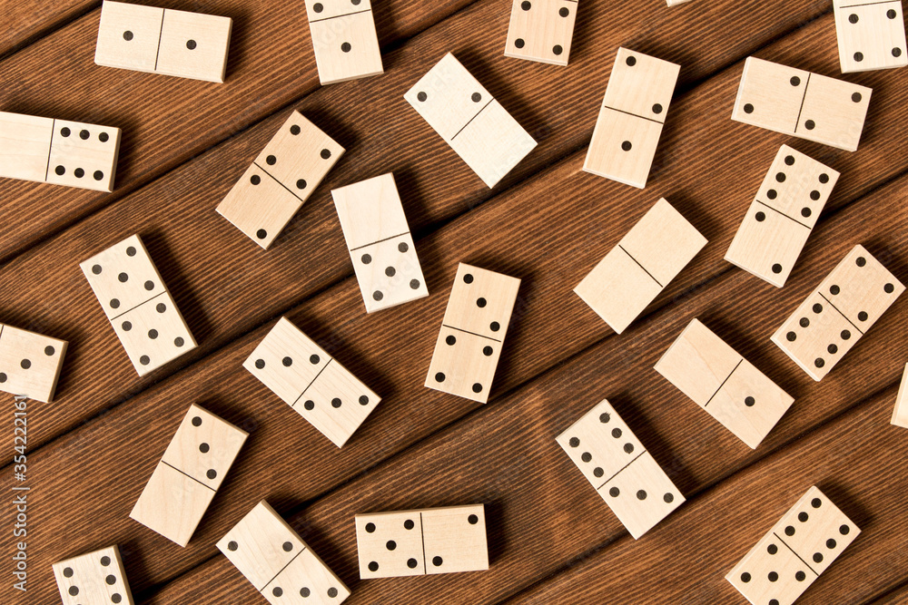 Domino. A game of dominoes on a wooden table. Domino. A game of dominoes on a wooden table.