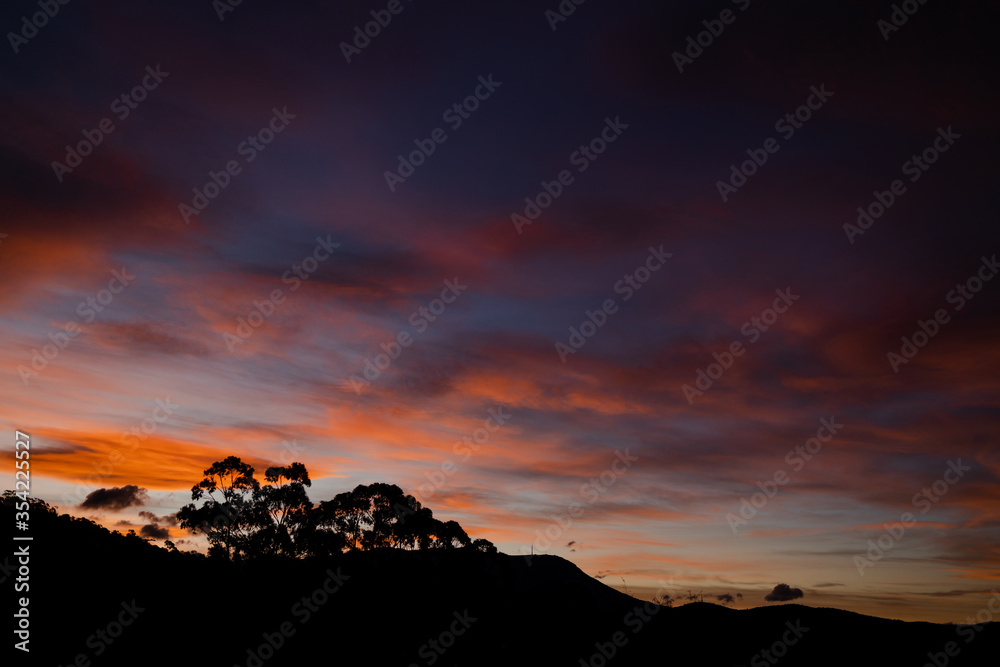 sunset sky with beautiful pink clouds over the hills of Tasmania sunset sky with beautiful pink clouds over the hills of Tasmania
