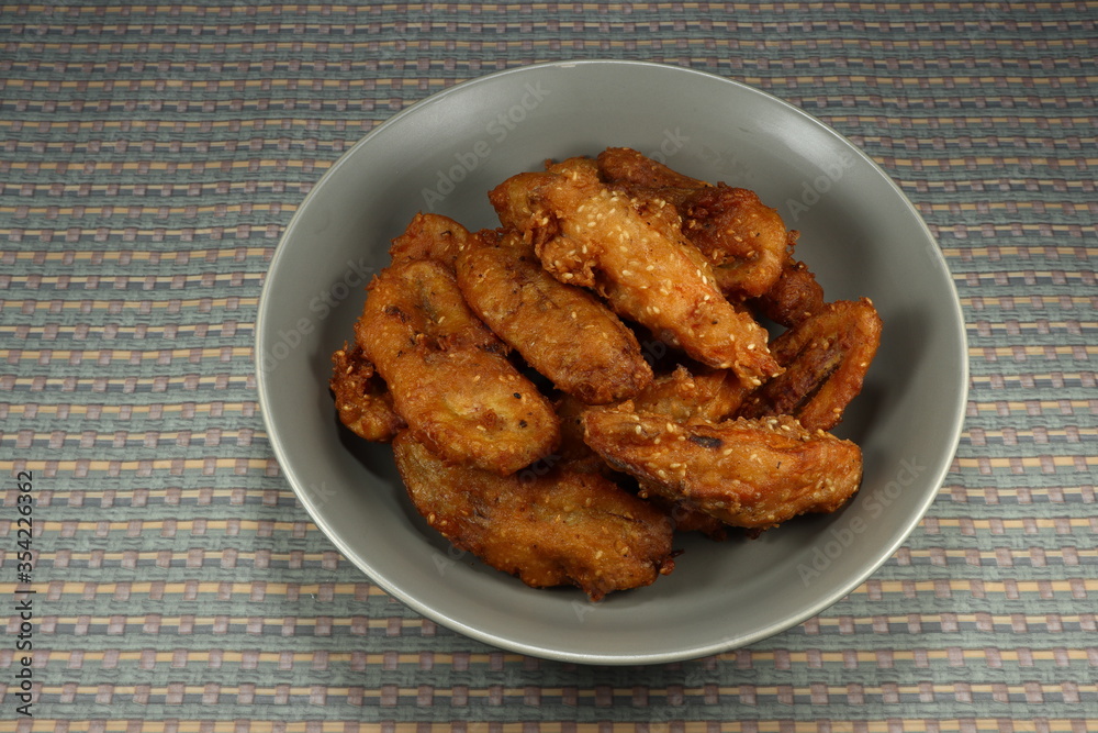 Traditional Deep fried cutting of raw cultivated banana and potato seasoning with local flavor and sesame on the plate. Famous snack in Asia. Fatty menu. Traditional Deep fried cutting of raw cultivated banana and potato seasoning with local flavor and sesame on the plate. Famous snack in Asia. Fatty menu.