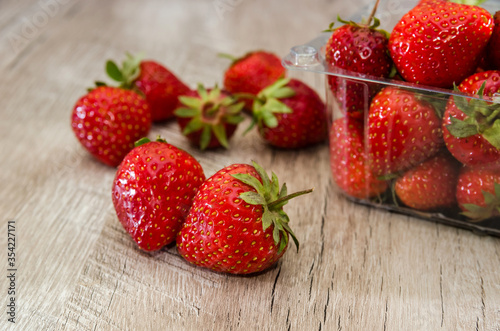 tasty strawberries on a wooden background. A lot of strawberries on the table.