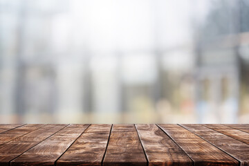 Empty wood table top and blur glass window interior restaurant banner mock up abstract background - can used for display or montage your products.