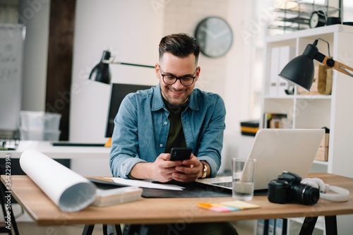 Portrait of handsome businessman. Man using phone. 