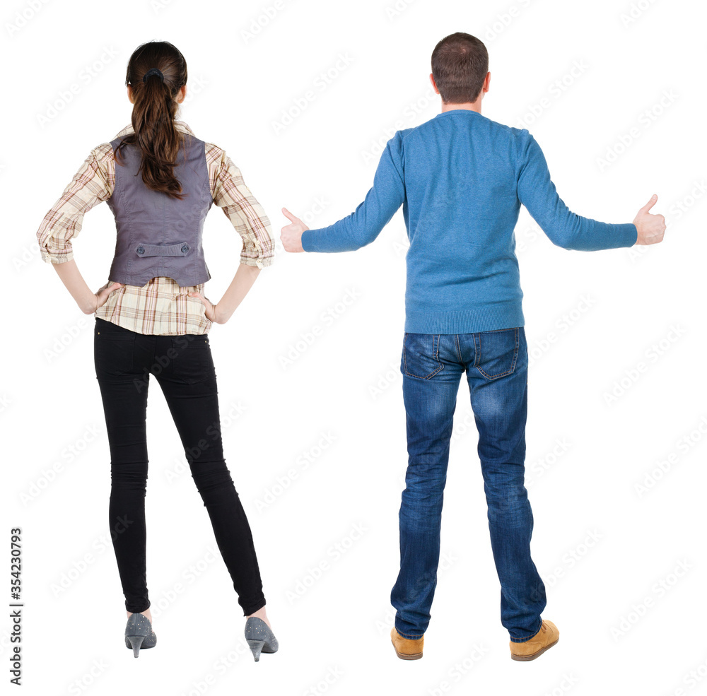 Obraz premium Back view of couple in sweater showing thumbs up.