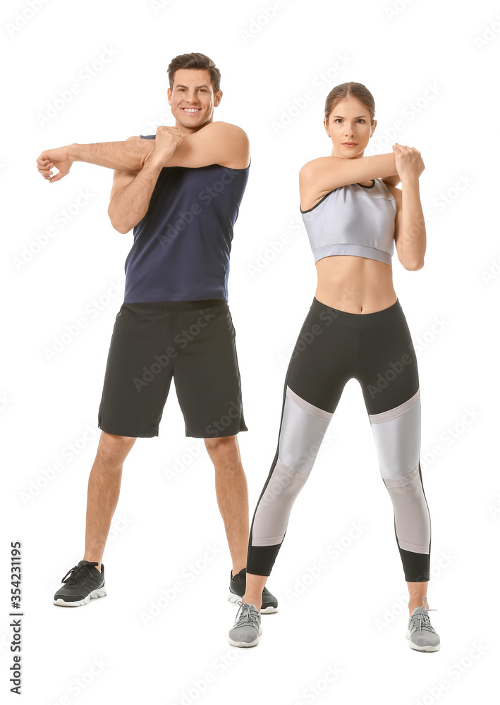 Sporty young couple training on white background Sporty young couple training on white background