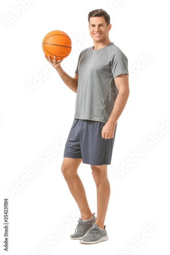 Sporty young man with ball on white background © Pixel-Shot