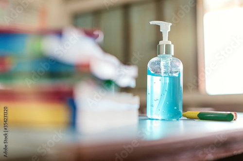 New Normal. COVID-19 prevention and protection in school,Pocket antiseptic hand sanitizer gel on the table with classroom background,corona virus prevention medical hand sanitizer gel,hydro alcoholic