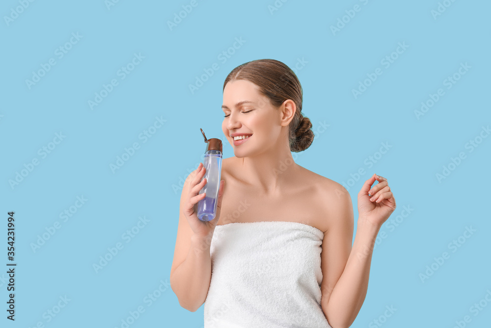 Beautiful young woman with shower gel on color background Beautiful young woman with shower gel on color background
