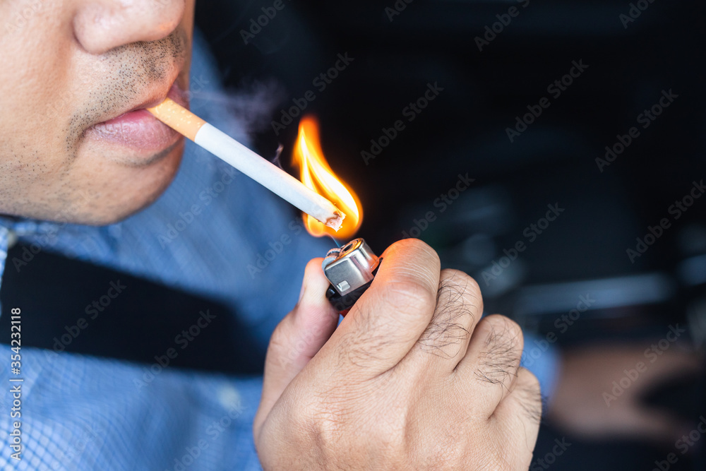Young man smoking a cigarette in car. Young man smoking a cigarette in car.