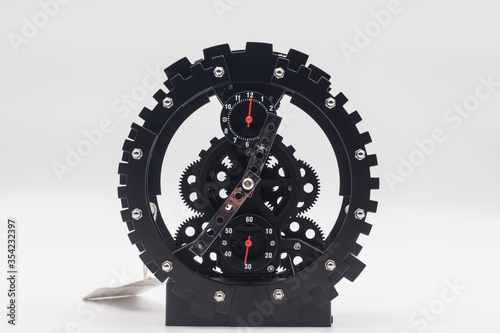 Black clock with Gears shape referring to engineering Isolated on a white background