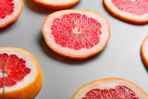 Fresh cut grapefruit on grey background