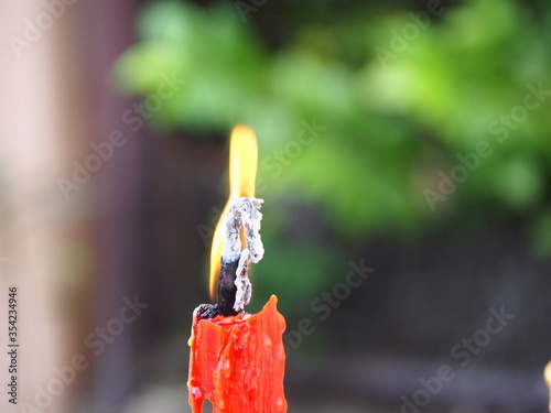 Close up of a burning candle flame. Melted Wax Candle light border design creating a spiritual atmosphere photo