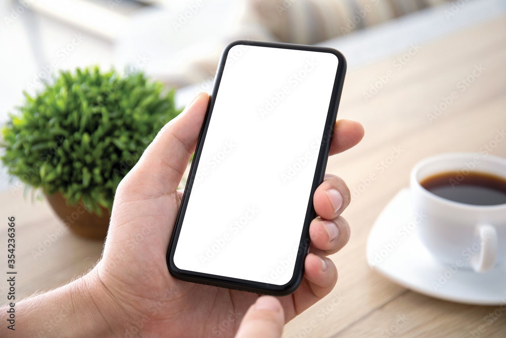 male hands holds phone with isolated screen over table male hands holds phone with isolated screen over table