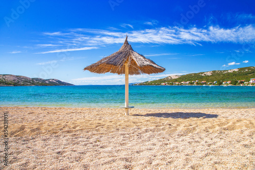 Fototapeta Naklejka Na Ścianę i Meble -  Adriatic sea shore in Croatia on Pag island, parasol on beautiful Puntica sand beach
