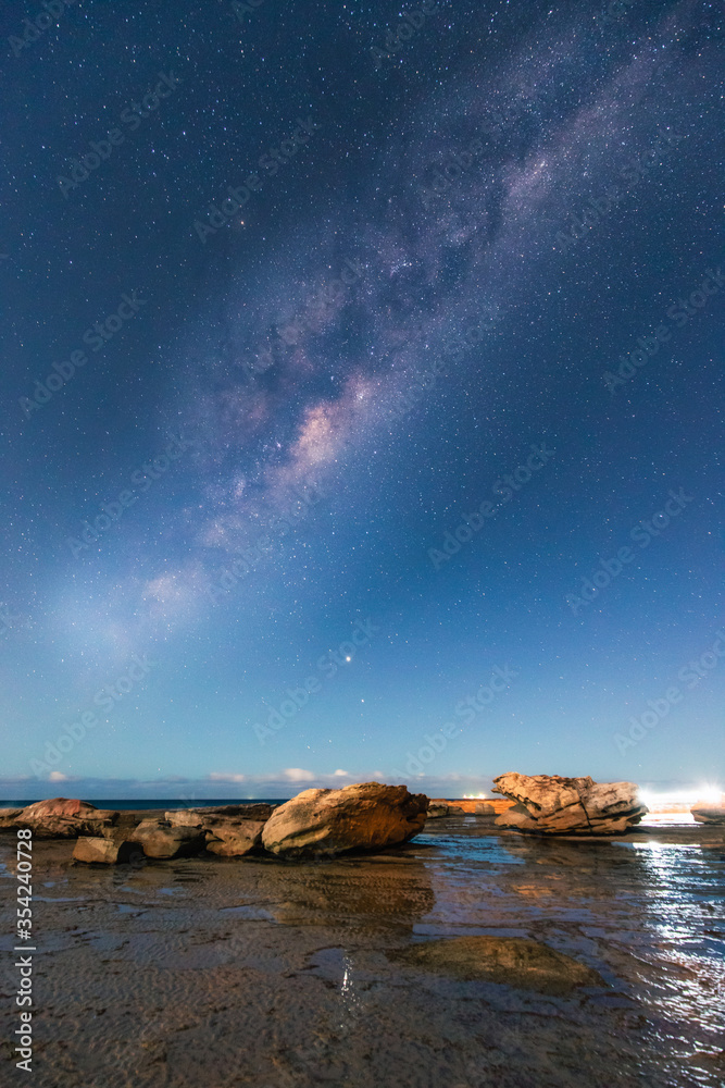Milky way view over the rocky coastline of Coalcliff, NSW, Australia.